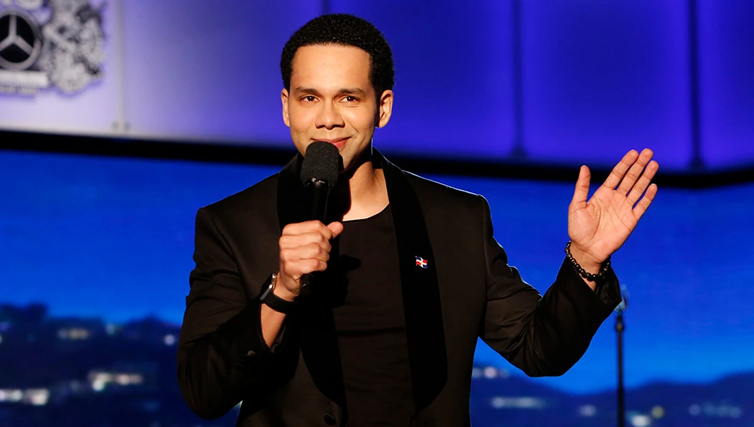 Vladimir Caamano holding a microphone on stage during a performance or appearance.
