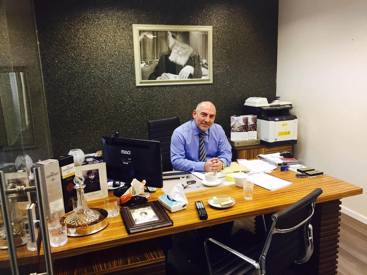 Meir Aryeh Velenski seated at a desk in an office