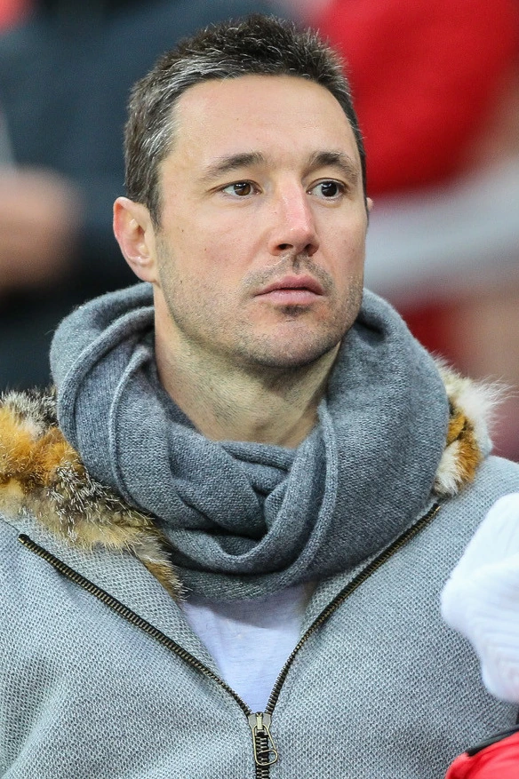 Ilya Kovalchuk at an event, wearing a gray scarf and jacket