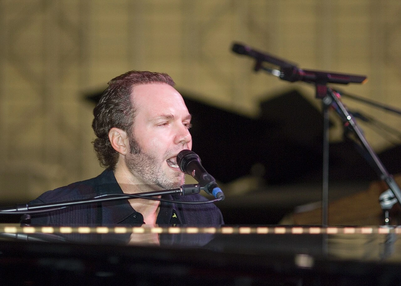 John Ondrasik performing at a microphone on stage