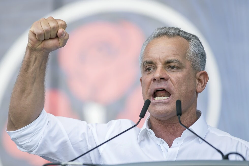 Vladimir Plahotniuc speaking at a podium with his fist raised during a public event