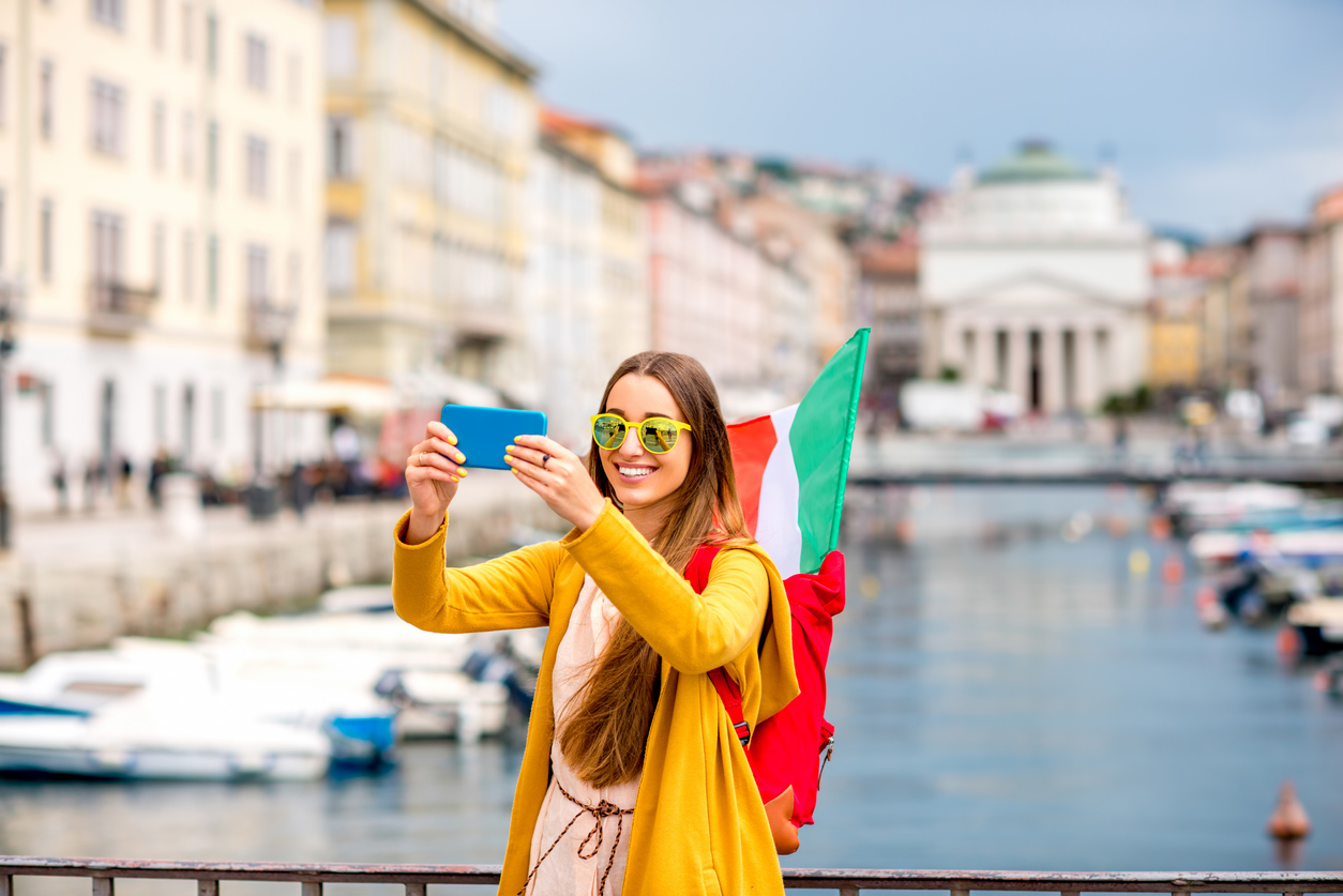 Junge Frau macht mit dem Smartphone ein Selfie in Triest