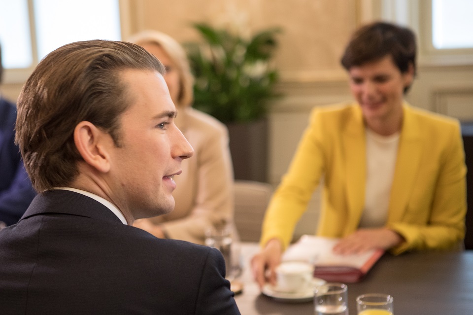 Sebastian Kurz von hinten im Profi. Pamela Rendi-Wagner sitzt mit ihm am Tisch. Sie ist im Hintergrund und unscharf.