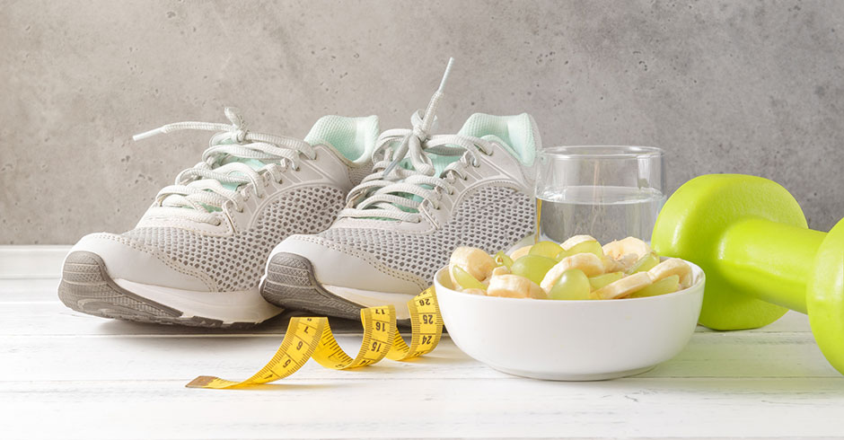 Ein paar Sportschuhe neben einer Schüssel Haferflocken mit Bananen | Credit: iStock.com/ElenaBoronina