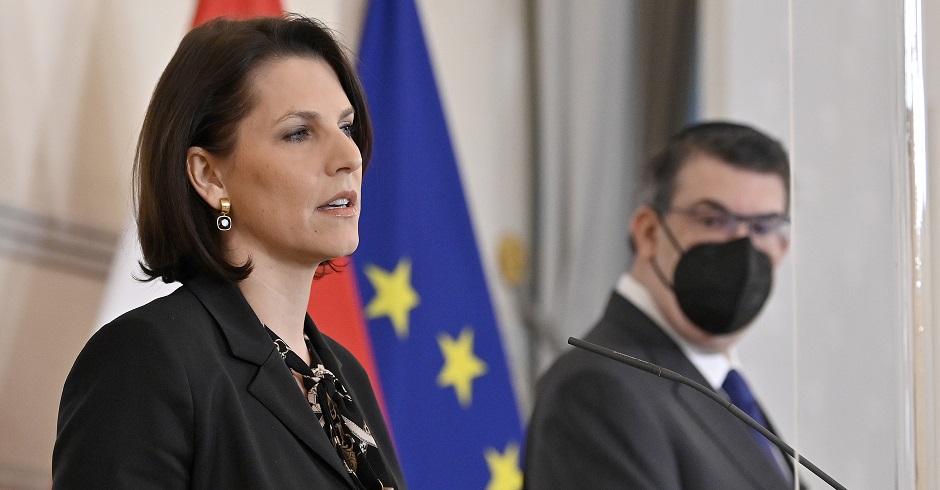 Europaministerin Karonline Edstadler bei einer Pressekonferenz vor den Flaggen Österreichs und der EU