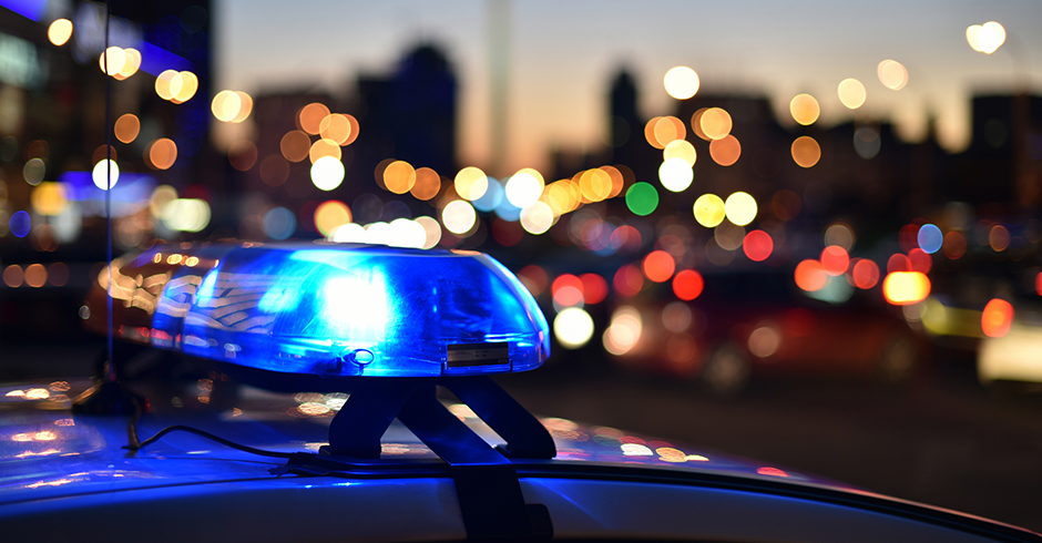 Polizeiauto mit Blausignal in einer amerikanischen Großstadt | Credit: iStock.com/Oleksandr Filon