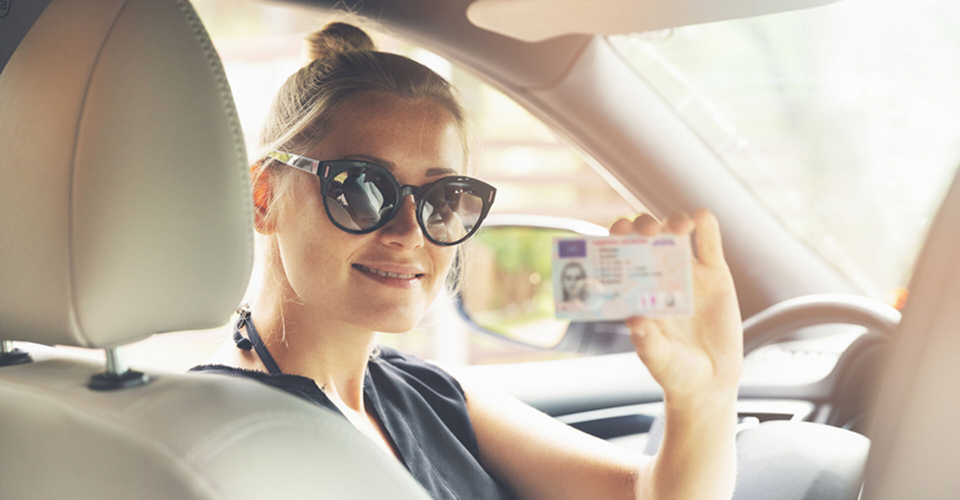 Junge Frau mit neuem Führerschein | Credit: iStock.com/ronstik