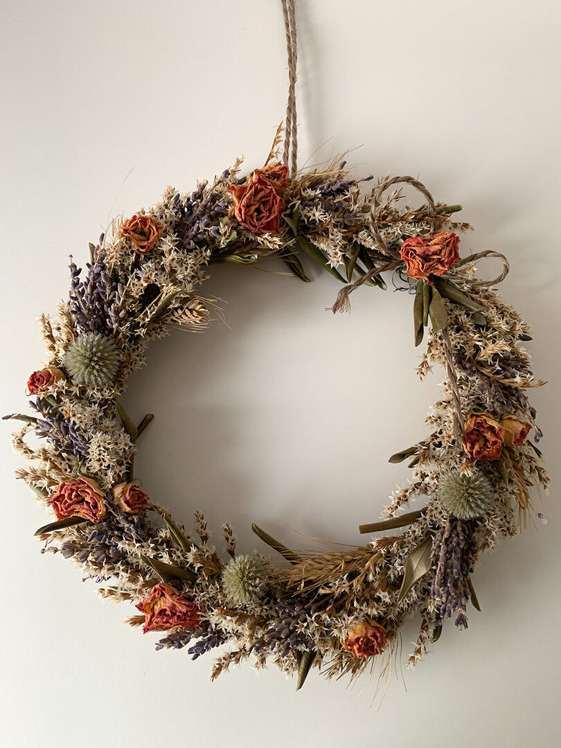 Trockenblumenkranz an der Wand | Credit: iStock.com/lapasmile