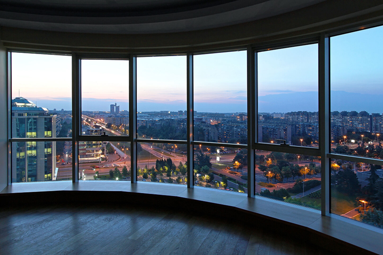 Glasfassade eines Hochhauses mit herrlichem Ausblick auf die Großstadt | Credit: iStock.com/Baloncici