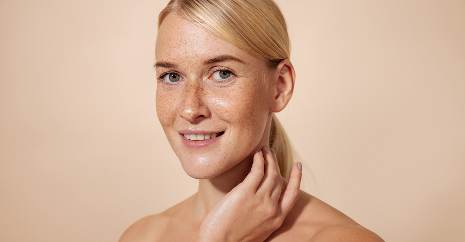 Porträt junge blonde Frau mit Sommersprossen