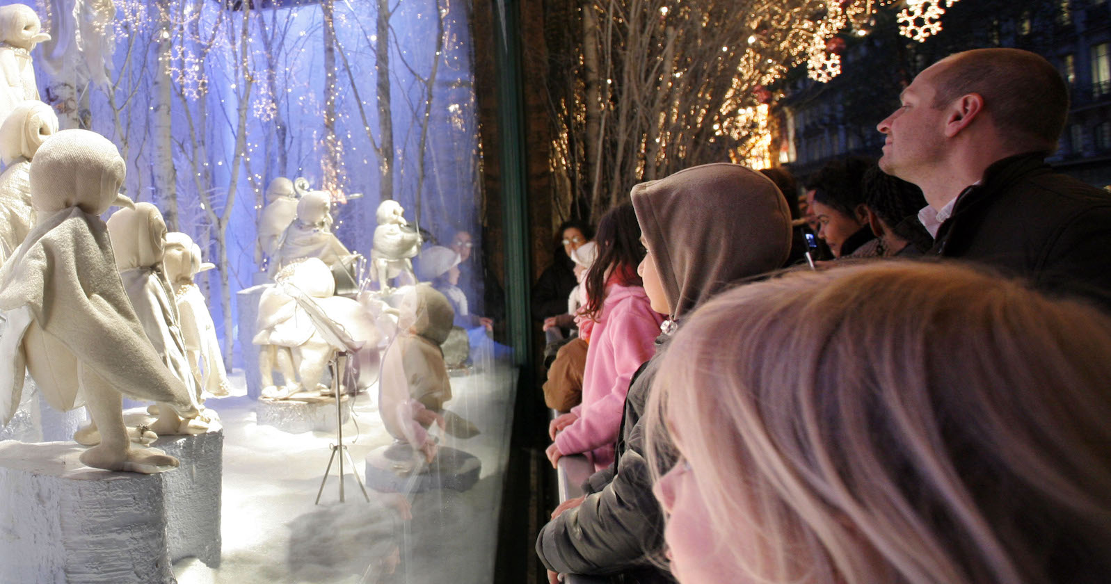 Kind schaut in beleuchtetes Schaufenster