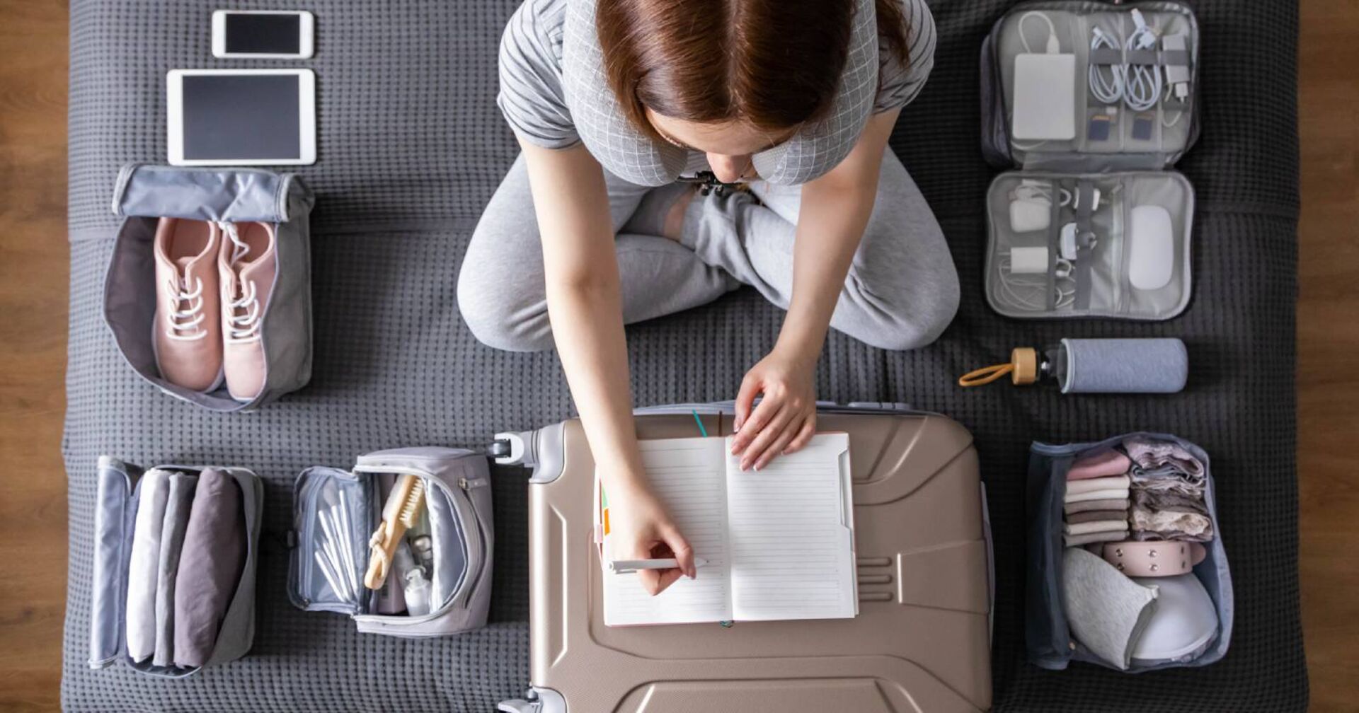 Junge Frau beim Kofferpacken | Credit: iStock.com/Kostikova