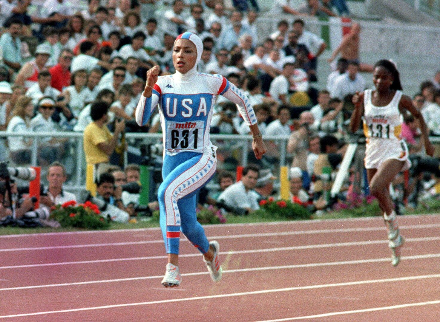 Die Sprinterin Florence Griffith Joyner, die in einem badeanzugähnlichen Outfit über die Laufbahn fegt.