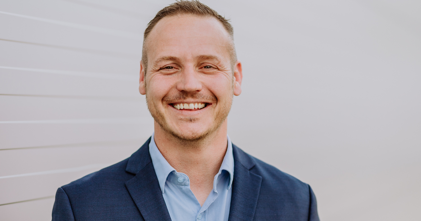 Michael Feike lächelt im Anzug | Credit: Michael Feike
