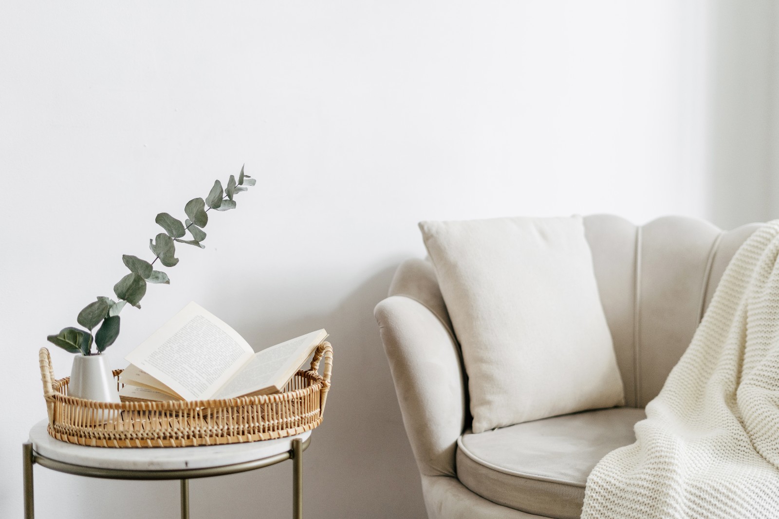 Weißer Loungesessel steht vor einer weißen Mauer | Credit: iStock.com/brizmaker