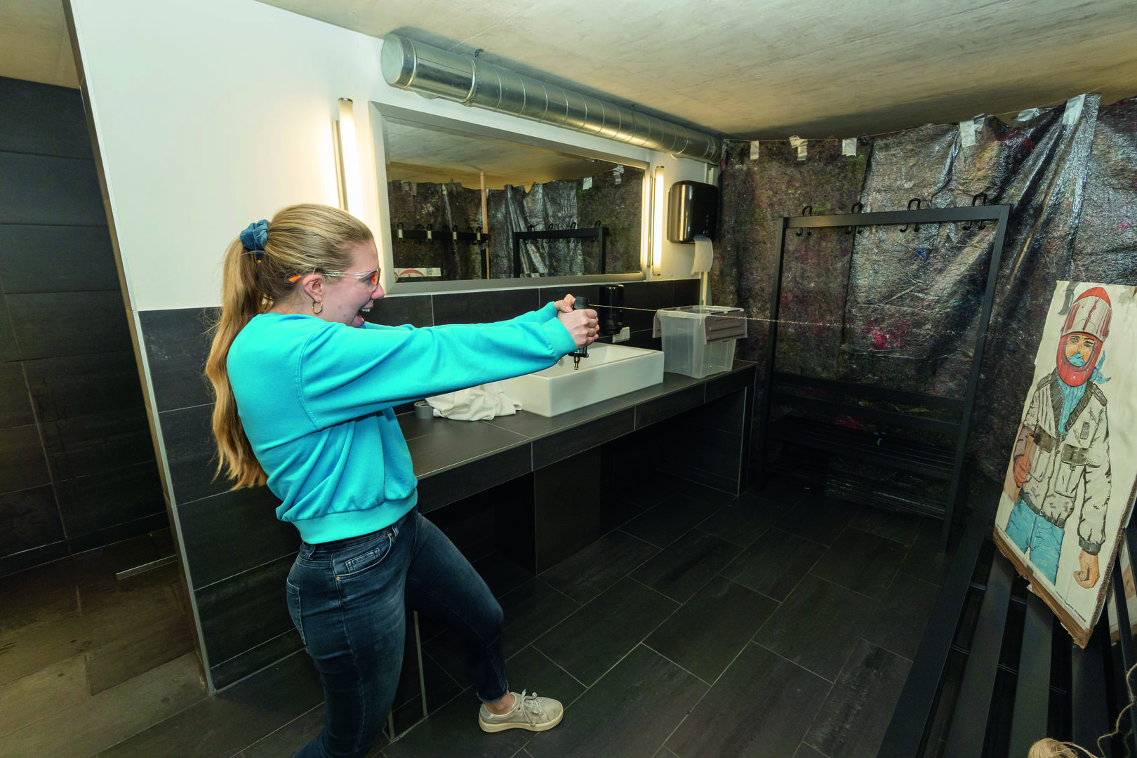 Frau sprüht mit Pfefferspray auf ein Schild