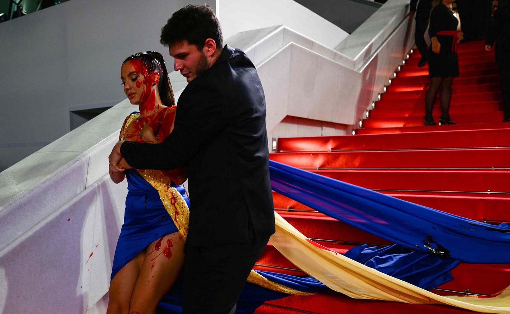 Aktivistin wird von Sicherheitskräften weggeführt