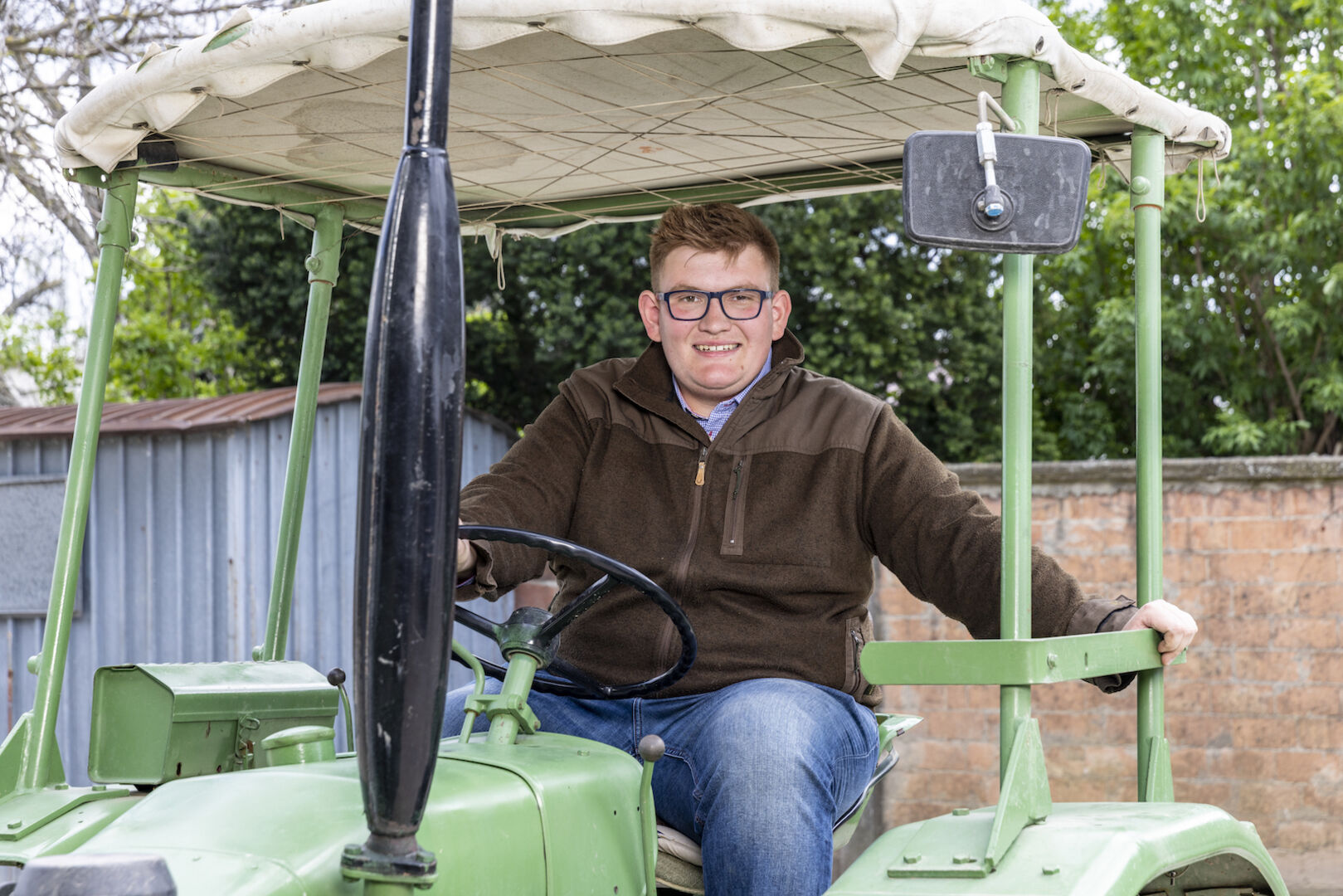 Michael sitzt auf einem Traktor.