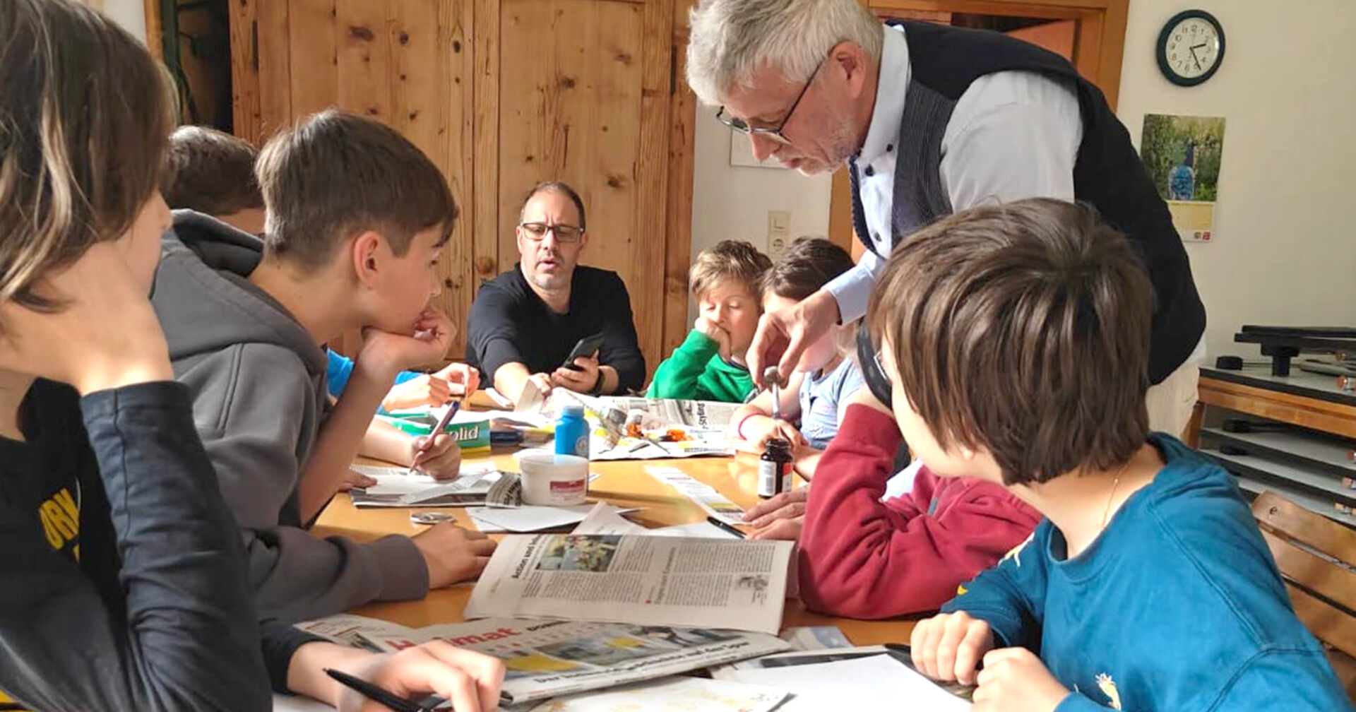 Vereinsgründer Jürgen Peter zeigt im Jugendworkshop, wie Zaubertricks mit Zeitungen vorbereitet werden.