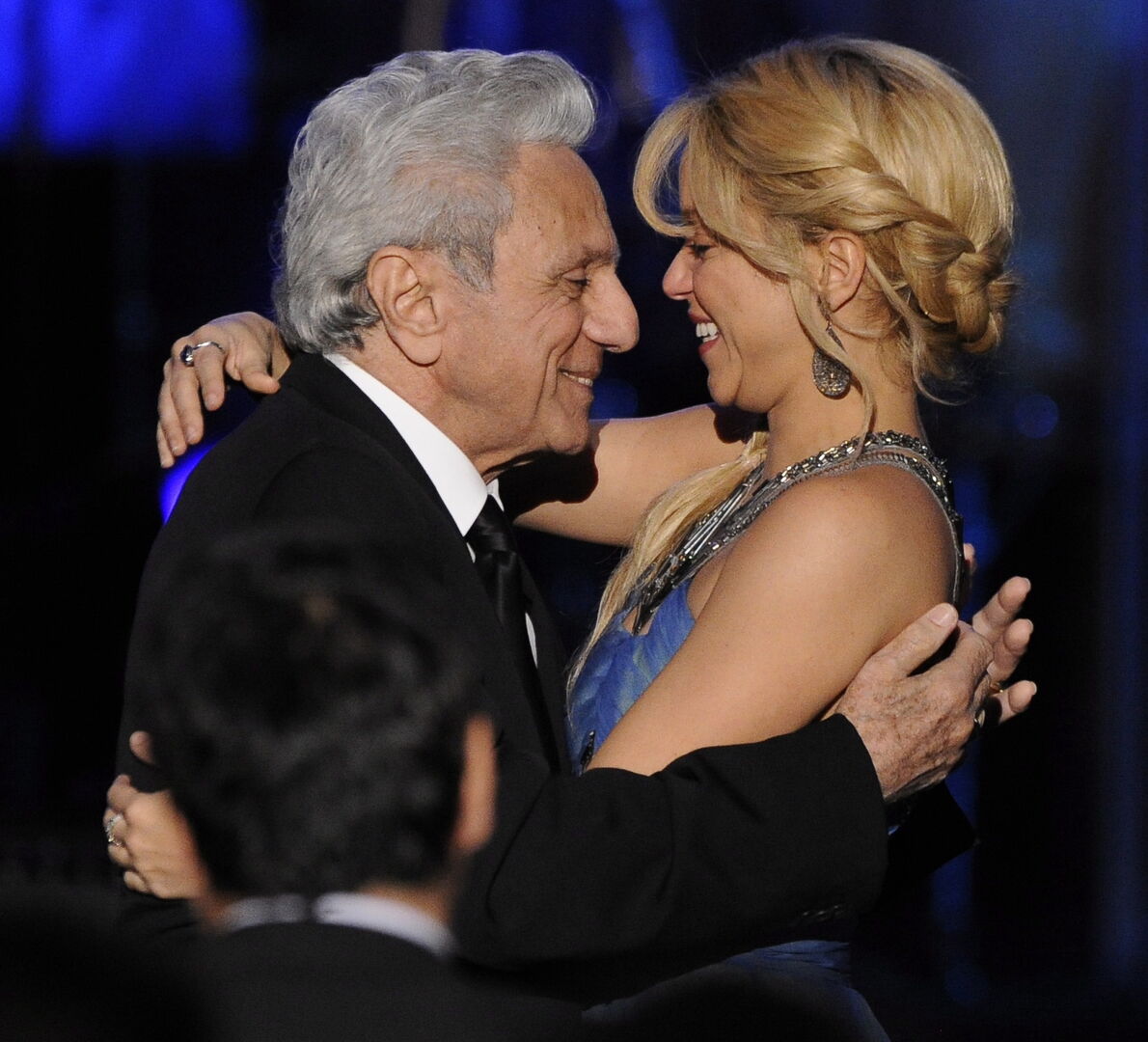 Eine junge Frau umarmt einen alten Mann