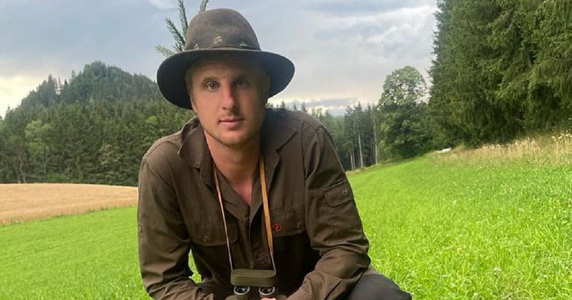 Martin Hinteregger posiert in Jagdkluft auf einer Wiese, er kauert im Gras