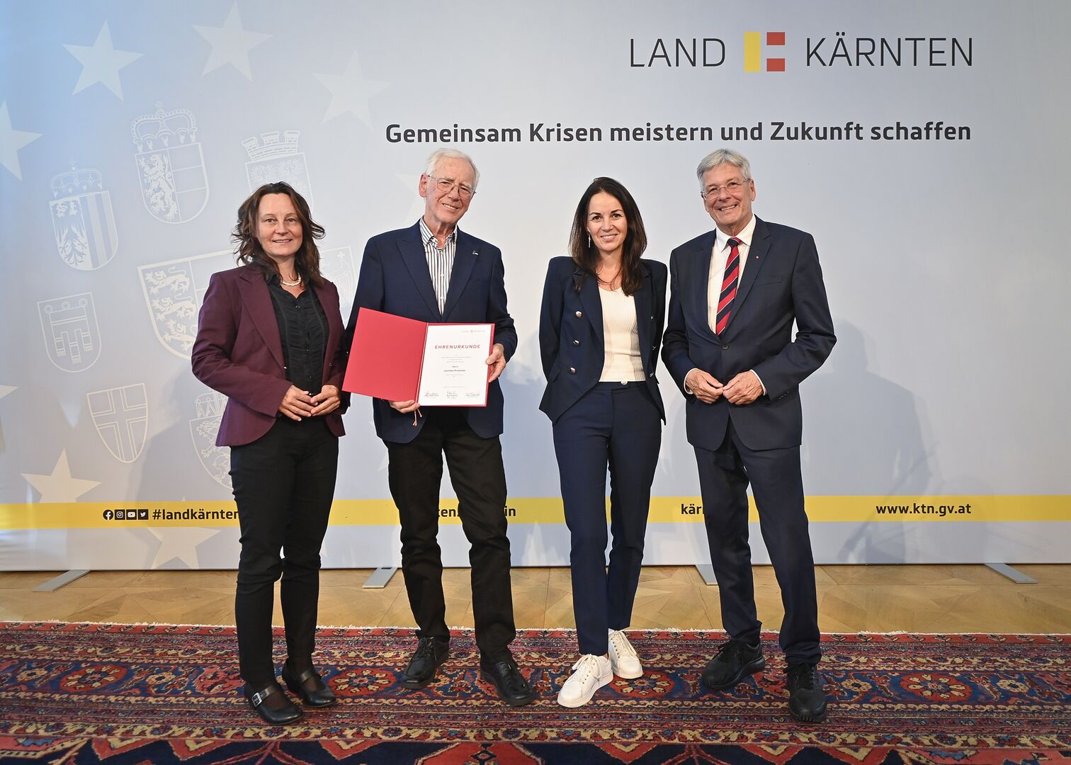 Vertreter vom Land Kärnten mit Günther Prommer, der eine Auszeichnung in den Händen hält