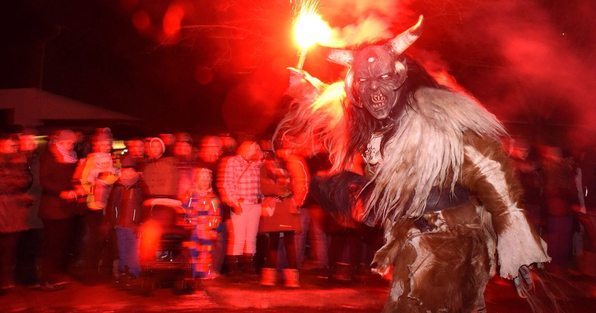 Ein Krampus bei einem Perchtenlauf vor Publikum.