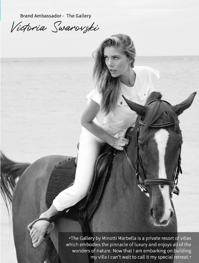 Victoria Swarovski auf einem Pferd mit einem weißen T-Shirt und einer weißen Hose. Ihre Haare sind offen und sie trägt keine Schuhe.