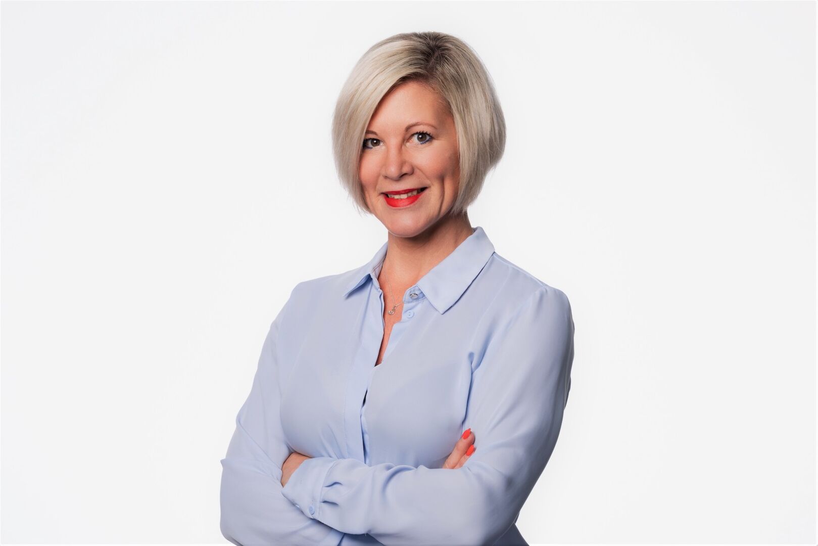 Porträt mit verschränkten Armen vor weißem Hintergrund