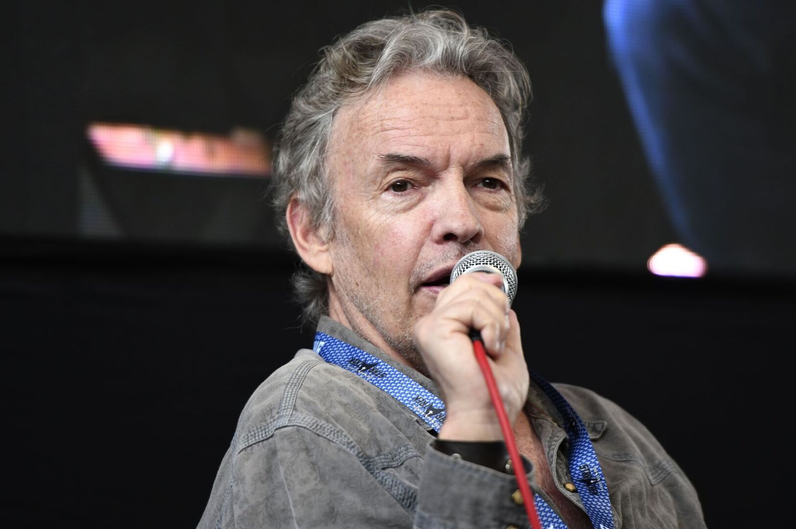 Gary Graham mit einem Mikrofon in der Hand.