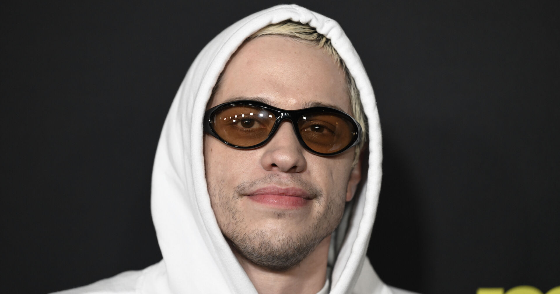 Pete Davidson mit einer Sonnenbrille und einem weißen Hoodie.