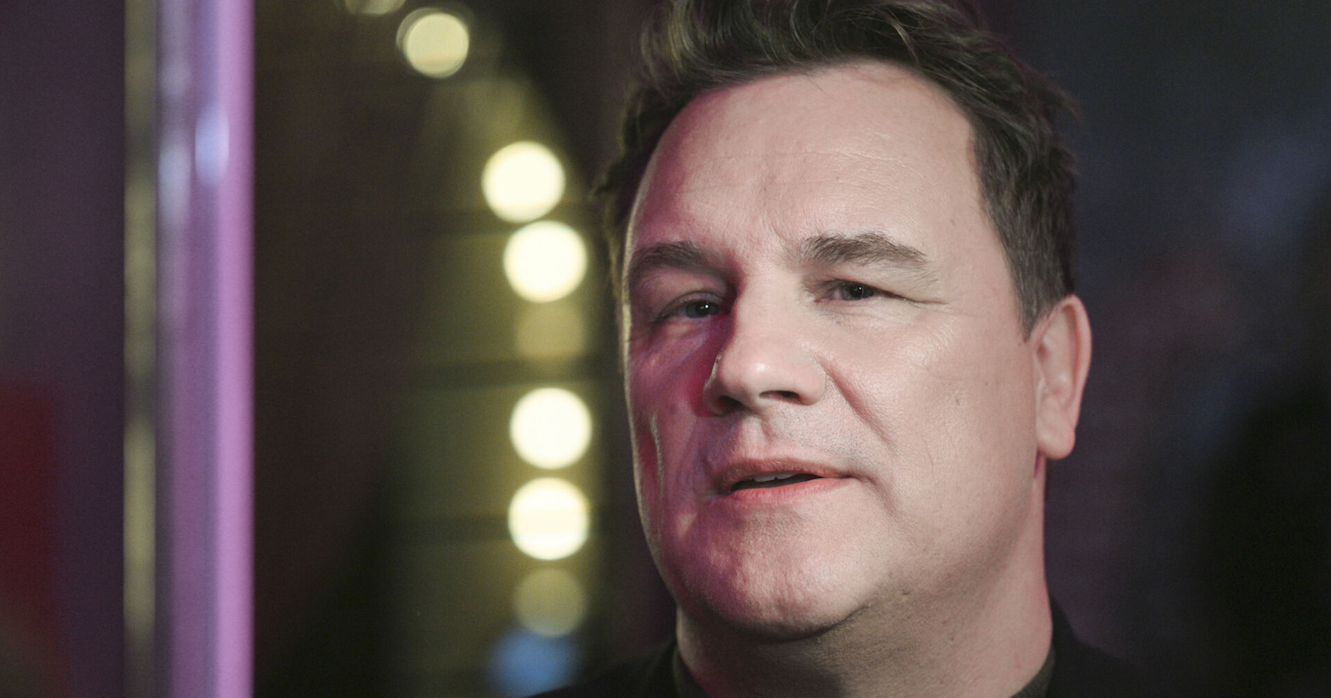 Porträt, im Hintergrund Bühnenlichter