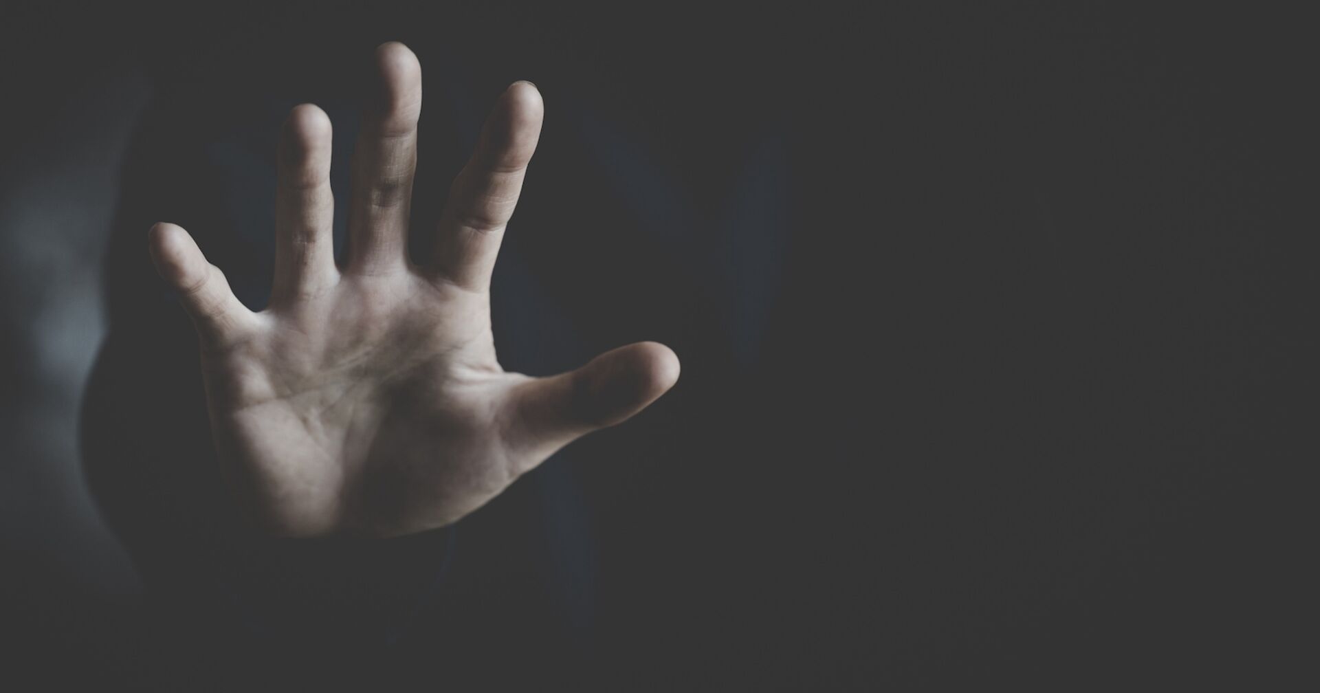 Die Hand eines Mädchens im Dunkeln.