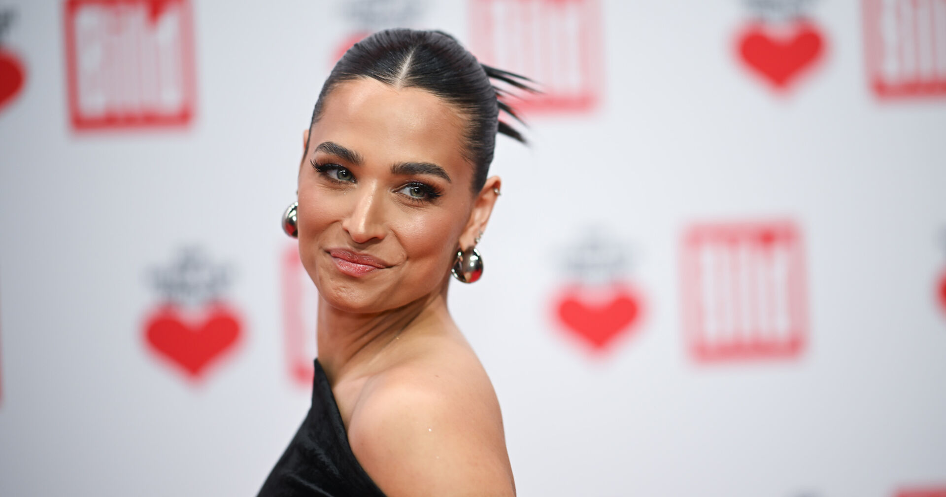 Amira Pocher mit hochgesteckten Haaren und starken Make Up auf dem Red Carpet.