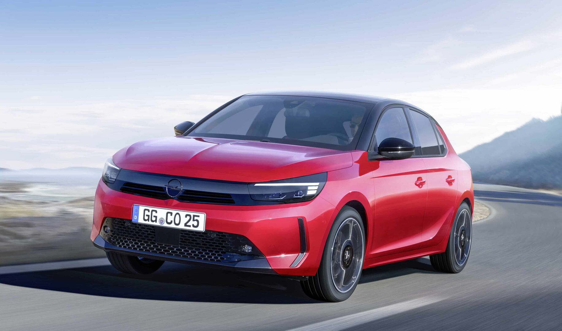 Ein roter Opel Corsa düst über eine Bergstraße. Er kommt diesen Frühling auf den Markt.