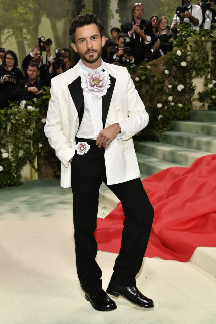 Ein Mann in einem schwarz-weißen Smoking mit Blumen-Applikationen