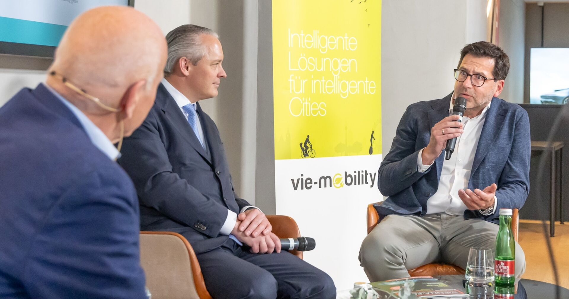 Drei Männer der Podiumsdiskussion