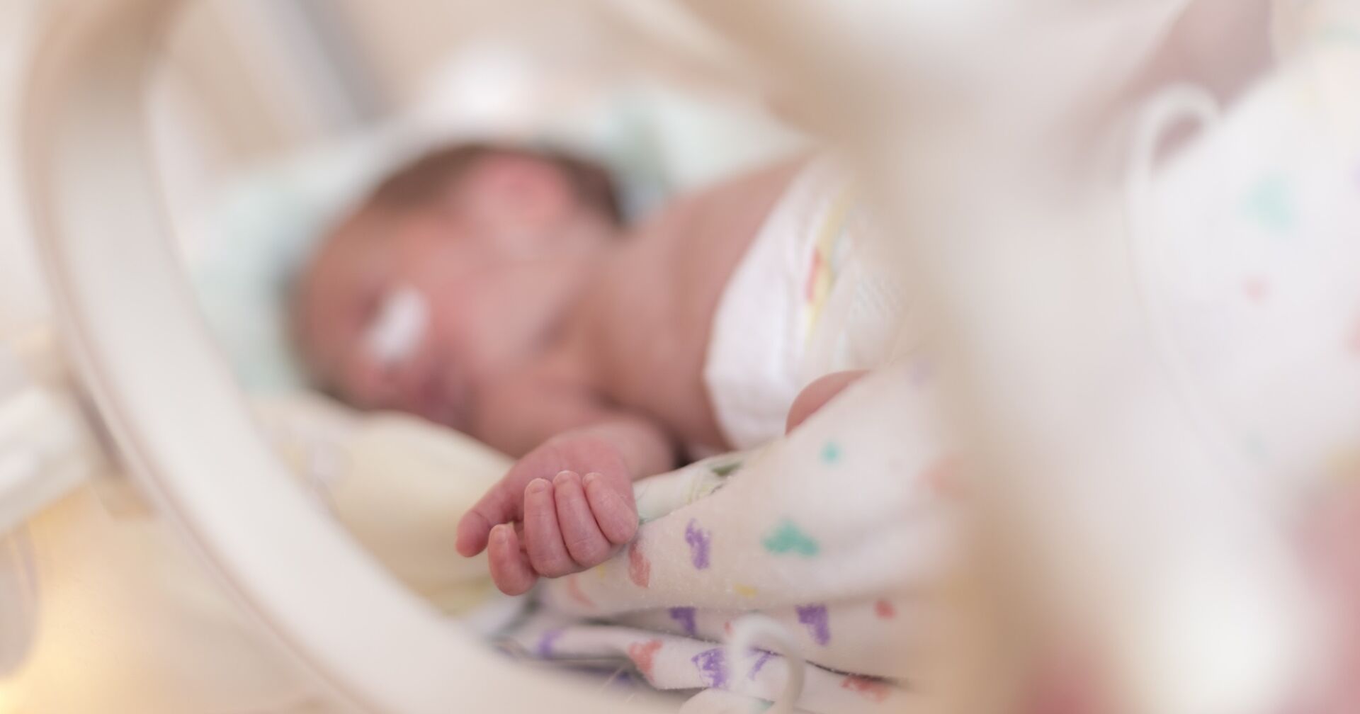 Eine Baby, dass auf der Intensivstation liegt.