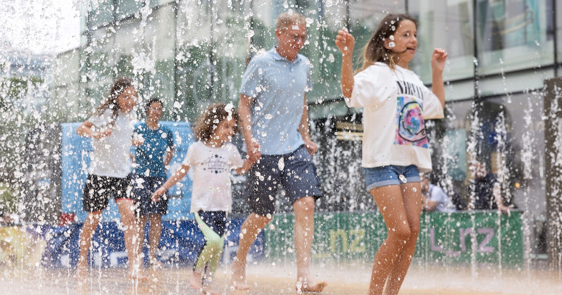Menschen laufen durch Wasserspielplatz