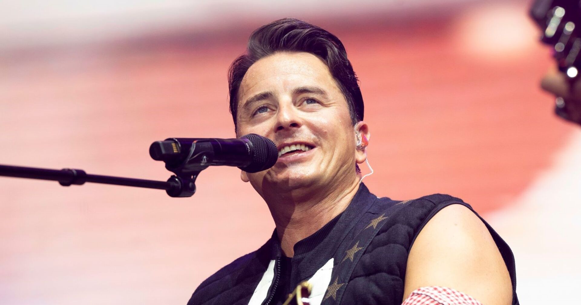 Andreas Gabalier singt in ein Mikrophon.