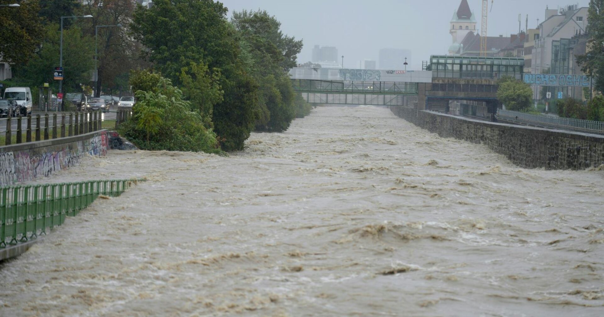 Der Wienfluss führt Hochwasser, Gehwege sind überschwemmt.