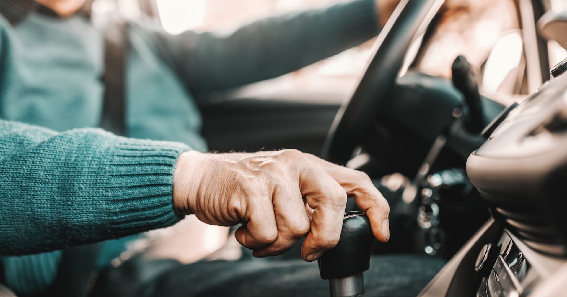 Ein betagter Mann hinterm Steuer eines Pkws.