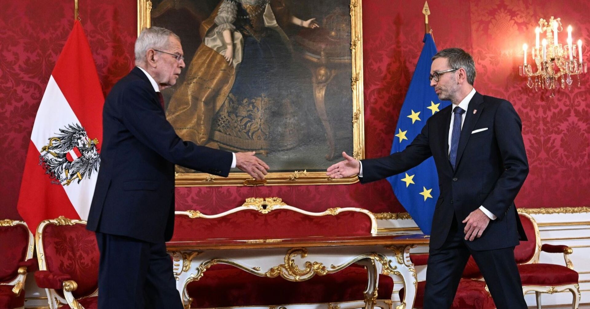 Alexander Van der Bellen und Herbert Kickl gehen in der Hofburg für den ersten Händedruck aufeinander zu, die Hände in der Mitte ausgestreckt