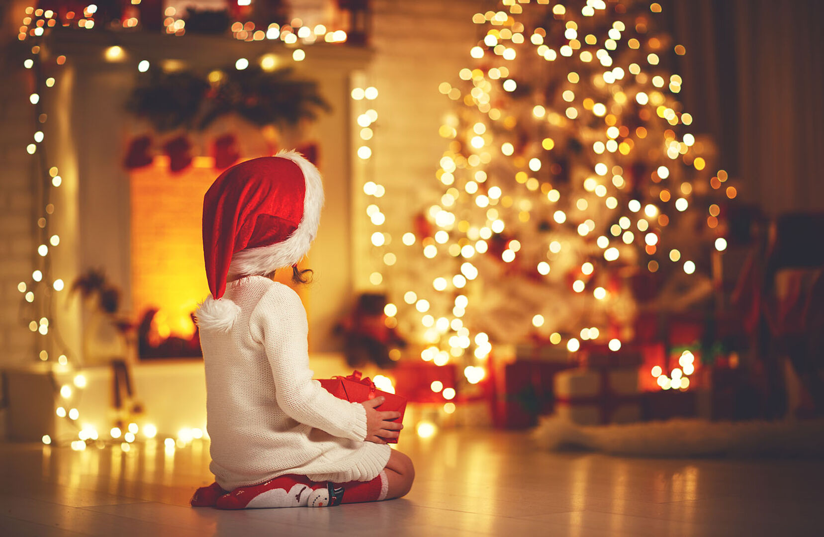 Kind mit Weihnachtsgeschenk | Credit: iStock.com/evgenyatamanenko