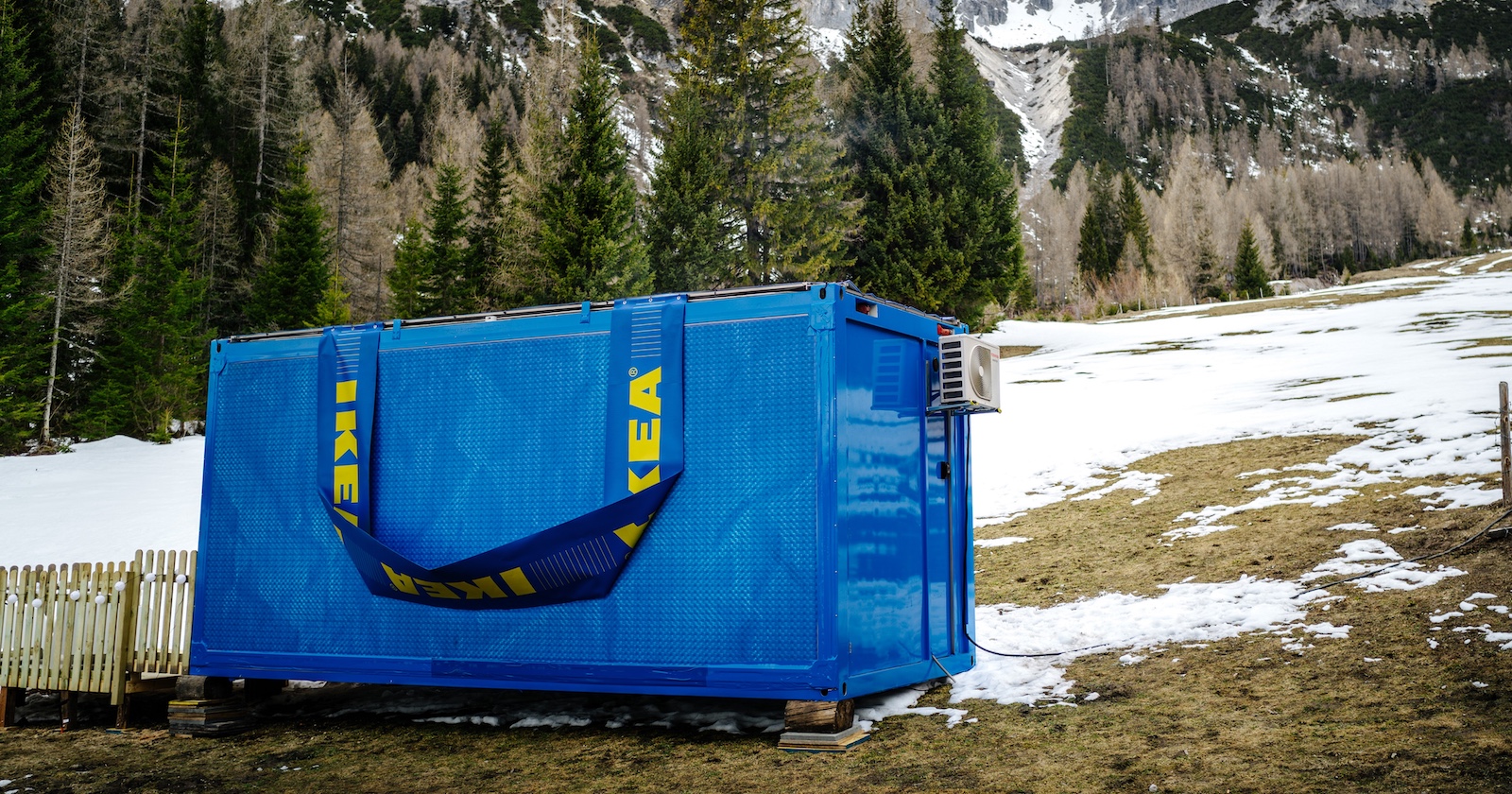 blauer Containter im Taschendesign auf einer winterlichen Bergwiese