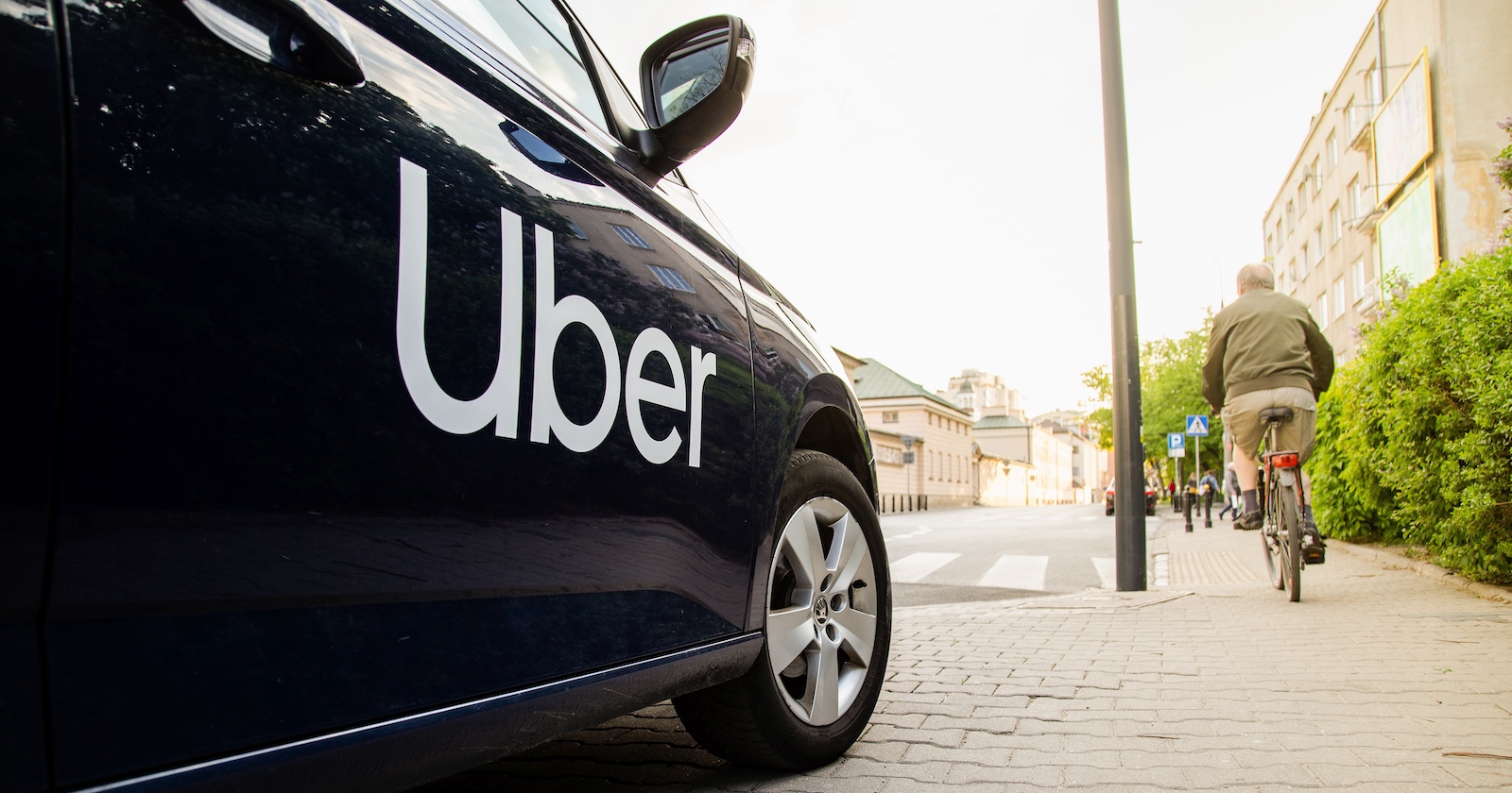 Ein Auto mit der Aufschrift &quot;Uber&quot; hält am Straßenrand.