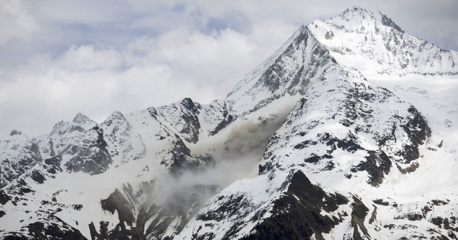 Am Kleinen Nesthorn hat sich ein Felssturz gelöst und donnert über den verschneiten Hang talwärts