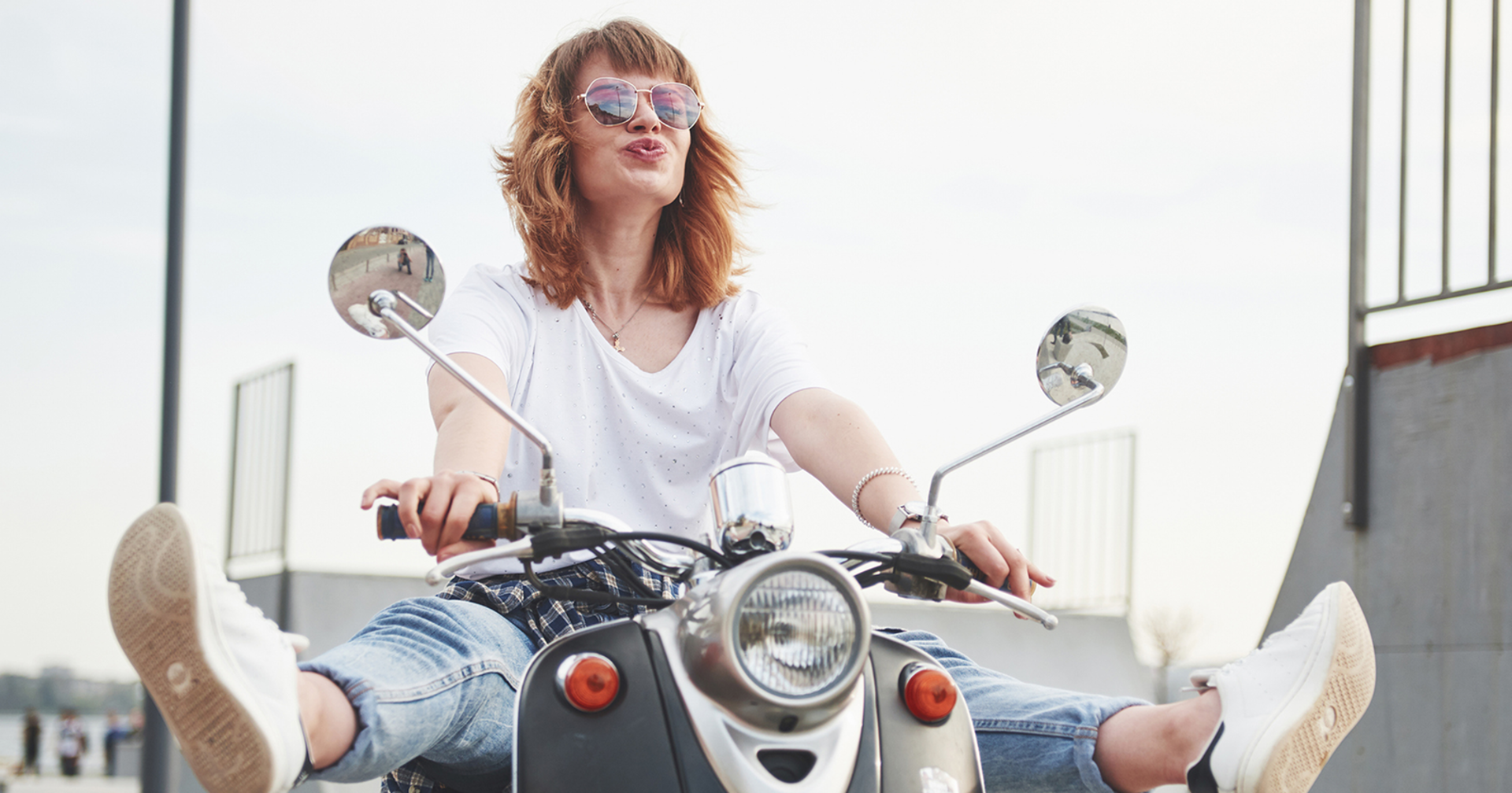 Frau sitzt auf Roller | Credit: iStock.com/standret