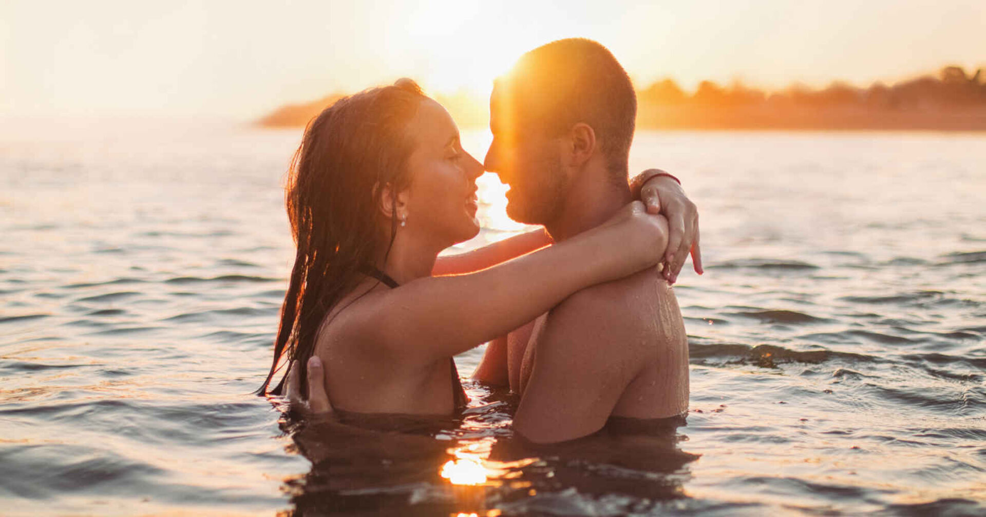 Eine Frau und ein Mann umarmen sich im Wasser