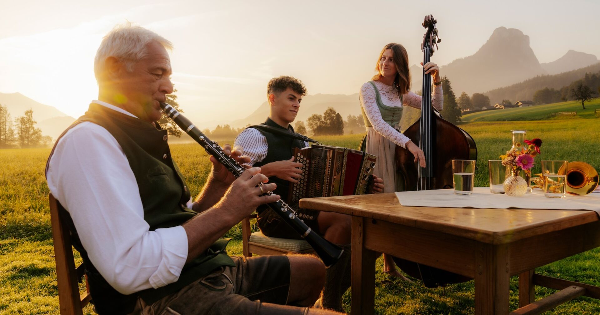 Drei Musikanten spielen auf einer Alm.
